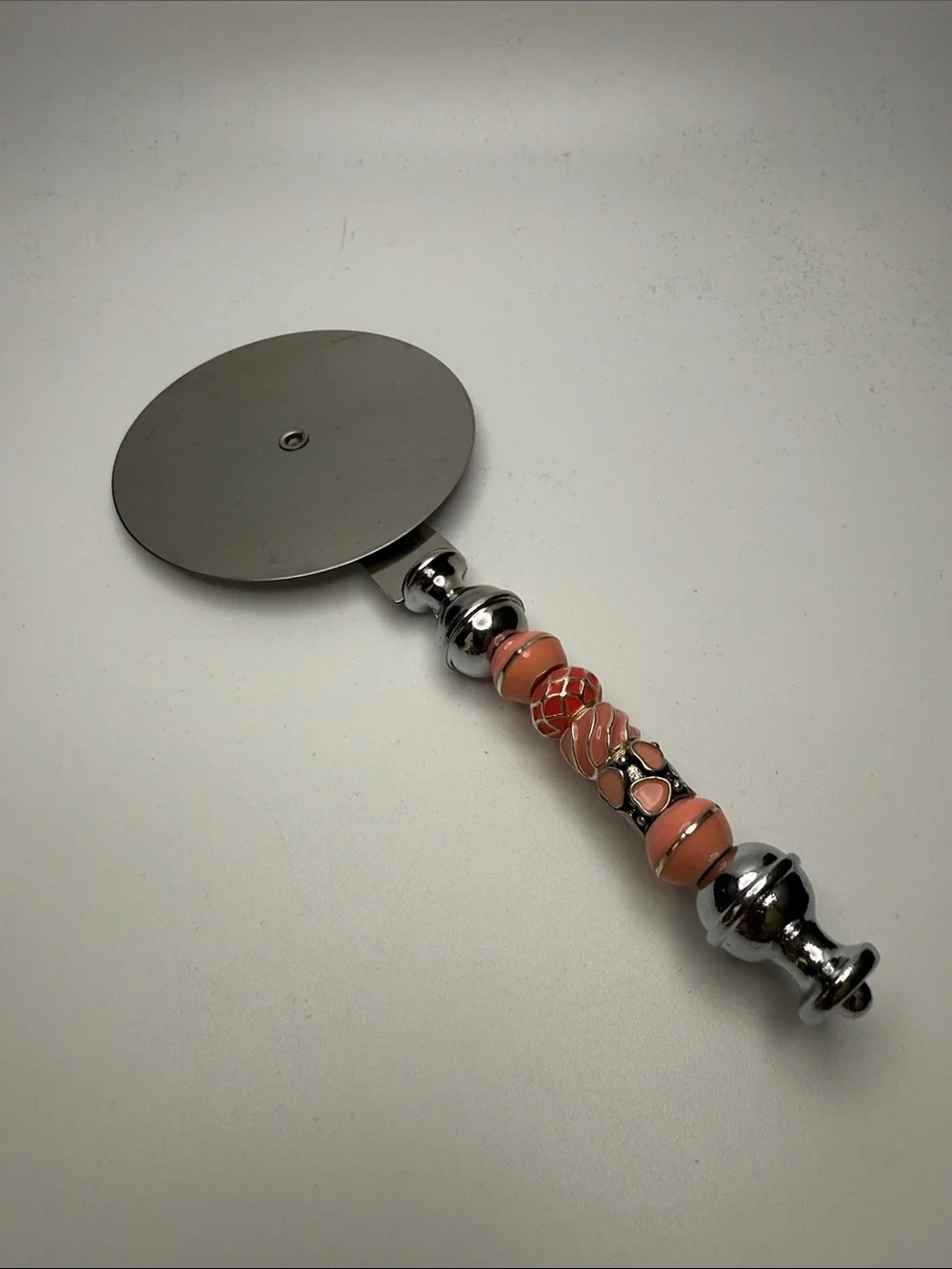 Decorative Coral-Peach Beaded Pizza Cutter with Chrome Handle